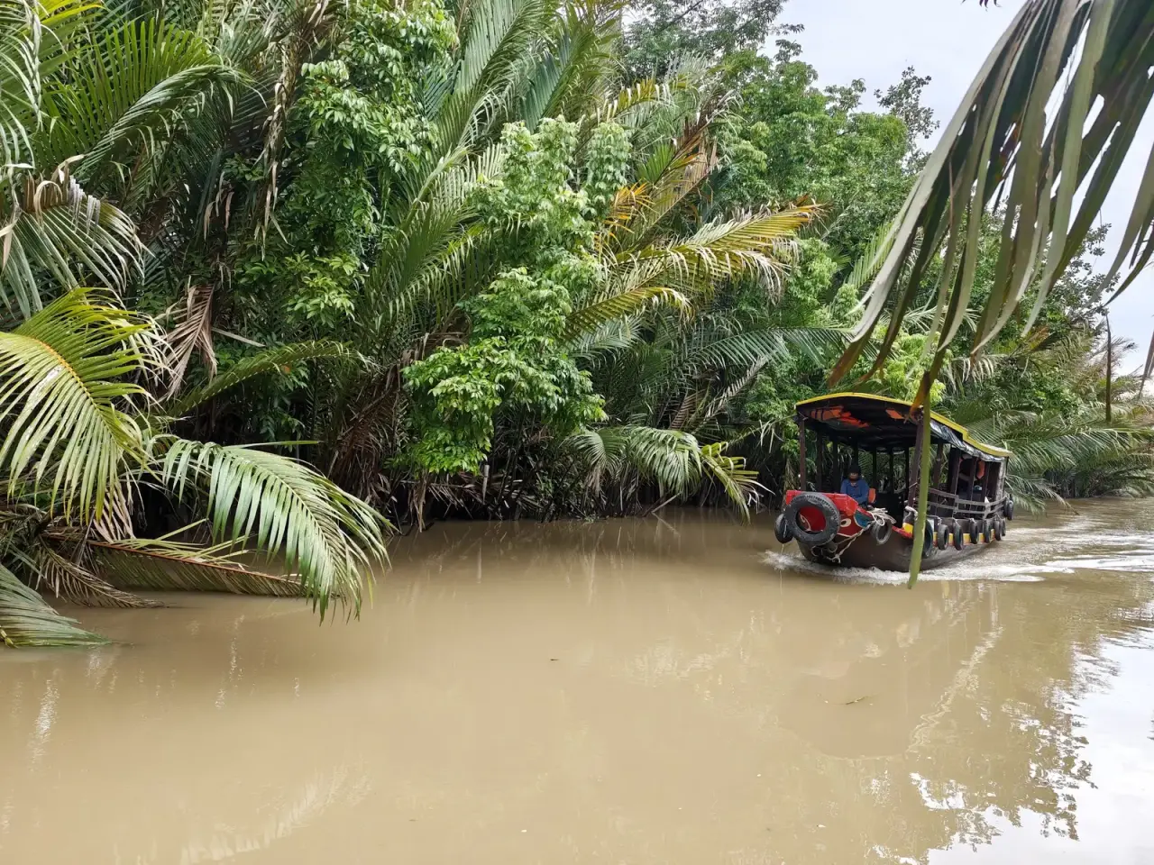 Covered wooden motorboat on the river